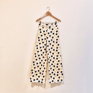 beige zara pants with black and yellow flower patterns. wide, high-waisted pants